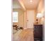 Bright foyer with wood-look tile floors, white door, and a stylish console table with a lamp at 769 Daybreak Pl, Longwood, FL 32750