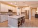 Bright kitchen with white cabinets, stainless steel appliances, and a large center island with seating at 769 Daybreak Pl, Longwood, FL 32750