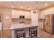 Bright kitchen with white cabinets, stainless steel appliances, and a large center island with seating at 769 Daybreak Pl, Longwood, FL 32750