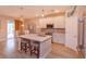 Bright kitchen with white cabinets, stainless steel appliances, and a large center island with seating at 769 Daybreak Pl, Longwood, FL 32750
