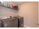 Functional laundry room with front-loading washer and dryer and overhead shelving for storage at 769 Daybreak Pl, Longwood, FL 32750