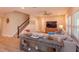 Cozy living room with staircase, tile floors, comfortable seating, and a large TV at 769 Daybreak Pl, Longwood, FL 32750