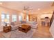 Open-concept living area with tile floors, large sectional sofa and views into kitchen at 769 Daybreak Pl, Longwood, FL 32750