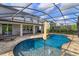 Beautiful outdoor screened pool area with ample lounge seating and a fountain at 769 Daybreak Pl, Longwood, FL 32750