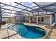 The unique freeform pool in a screened enclosure includes a fountain and ample lounge space at 769 Daybreak Pl, Longwood, FL 32750