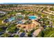 Aerial view of community pool, clubhouse, and surrounding homes at 9018 Stinger Dr, Davenport, FL 33896