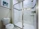 Modern bathroom featuring a glass-enclosed shower with white tile and decorative accents at 9018 Stinger Dr, Davenport, FL 33896
