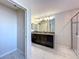 Bathroom featuring a dual sink vanity with granite countertops and tiled floors at 9018 Stinger Dr, Davenport, FL 33896