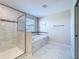 Bright bathroom featuring a walk-in shower, soaking tub, and tiled floors at 9018 Stinger Dr, Davenport, FL 33896