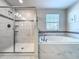 Bathroom with shower and bathtub combination, with tiled surround at 9018 Stinger Dr, Davenport, FL 33896