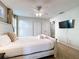Bright bedroom features a ceiling fan, TV, and neutral decor at 9018 Stinger Dr, Davenport, FL 33896