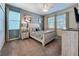 Comfortable bedroom featuring neutral tones, a ceiling fan, and ample natural light from multiple windows at 9018 Stinger Dr, Davenport, FL 33896