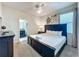 Bedroom featuring a black bed frame, carpet flooring, and an ensuite bathroom at 9018 Stinger Dr, Davenport, FL 33896