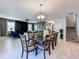 A spacious dining area connects the living room and staircase, featuring tile floors and modern lighting at 9018 Stinger Dr, Davenport, FL 33896