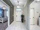 Entryway with white tile floors, neutral paint and plant decoration with views to other rooms at 9018 Stinger Dr, Davenport, FL 33896