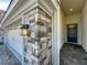 Close up of the front entry with gray stone accents, dark blue front door and paved walkway at 9018 Stinger Dr, Davenport, FL 33896