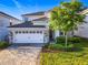 Beautiful two-story home with a two car garage, a stone accents and a well manicured lawn at 9018 Stinger Dr, Davenport, FL 33896