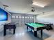 Game room area equipped with a foosball table, pool table, and air hockey at 9018 Stinger Dr, Davenport, FL 33896