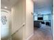 Hallway leading to a living room with a ceiling fan and TV near a staircase at 9018 Stinger Dr, Davenport, FL 33896