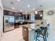 Modern kitchen with stainless steel appliances, granite countertops, and a breakfast bar with seating at 9018 Stinger Dr, Davenport, FL 33896