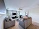 A cozy living room featuring carpet, ceiling fan, TV and comfortable seating at 9018 Stinger Dr, Davenport, FL 33896