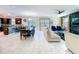 Open floorplan with connecting living room, dining and kitchen and white tile flooring at 9018 Stinger Dr, Davenport, FL 33896