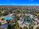 A stunning aerial view showcases a large community pool with multiple water features and ample lounging space at 9018 Stinger Dr, Davenport, FL 33896