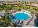 Overhead view of the community pool with ample seating, umbrellas, and beautiful landscaping at 9018 Stinger Dr, Davenport, FL 33896