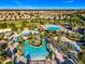 An aerial photograph highlights a large community pool area with water features, palm trees, and sunbathing spots at 9018 Stinger Dr, Davenport, FL 33896