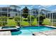 Sparkling screened-in pool with hot tub and lush landscaping at 9018 Stinger Dr, Davenport, FL 33896