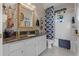 Bathroom featuring a single sink, granite countertop, framed mirror, and tub with shower at 9089 Saint Andrews Way, Mount Dora, FL 32757