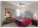 Main bedroom showcasing a decorative headboard, red bedspread, and side tables at 9089 Saint Andrews Way, Mount Dora, FL 32757
