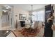Dining room with a modern chandelier, glass table, and sliding windows for ample natural light at 9089 Saint Andrews Way, Mount Dora, FL 32757