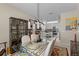 Open-concept dining area situated between the living room and kitchen, featuring modern decor at 9089 Saint Andrews Way, Mount Dora, FL 32757