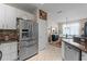 A kitchen view featuring a stainless steel refrigerator and light colored cabinets at 9089 Saint Andrews Way, Mount Dora, FL 32757
