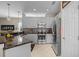Well-lit kitchen featuring modern appliances, granite countertops, and ample cabinet space at 9089 Saint Andrews Way, Mount Dora, FL 32757