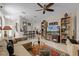Expansive living area connecting the dining and kitchen spaces, with tile flooring, and plenty of light at 9089 Saint Andrews Way, Mount Dora, FL 32757