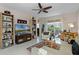 Bright and spacious living room featuring tile floors, built-in shelving, ceiling fan and ample natural light at 9089 Saint Andrews Way, Mount Dora, FL 32757