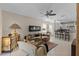 Open-concept living room seamlessly flows into a kitchen with sleek countertops and barstool seating at 9089 Saint Andrews Way, Mount Dora, FL 32757