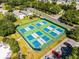 Aerial view of community pickleball courts with lush surroundings and parking available at 9089 Saint Andrews Way, Mount Dora, FL 32757