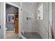 The bright shower features marbled tile and a bench inside at 9089 Saint Andrews Way, Mount Dora, FL 32757