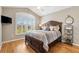 Bedroom featuring wood floors, ceiling fan, a window with shutters, and a queen bed at 973 Baisley Trl, The Villages, FL 32162