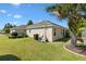 An exterior home view showing the side yard, landscape, and pool equipment at 973 Baisley Trl, The Villages, FL 32162