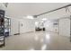 Spacious garage with white walls and epoxy flooring at 973 Baisley Trl, The Villages, FL 32162