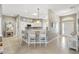 Open kitchen featuring an island with bar seating and granite countertops and white cabinets at 973 Baisley Trl, The Villages, FL 32162