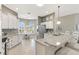 Kitchen showcasing a breakfast nook, stainless steel appliances, granite countertops, and white cabinets at 973 Baisley Trl, The Villages, FL 32162