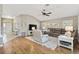 Cozy living room featuring hardwood floors, neutral paint, vaulted ceilings, and plush seating at 973 Baisley Trl, The Villages, FL 32162