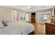 Main bedroom featuring tray ceiling, wood floors, and access to the lanai at 973 Baisley Trl, The Villages, FL 32162