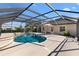 Relaxing pool area with outdoor seating and screened enclosure at 973 Baisley Trl, The Villages, FL 32162