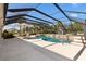 A beautiful screened-in pool with a patio set and an outdoor seating area at 973 Baisley Trl, The Villages, FL 32162